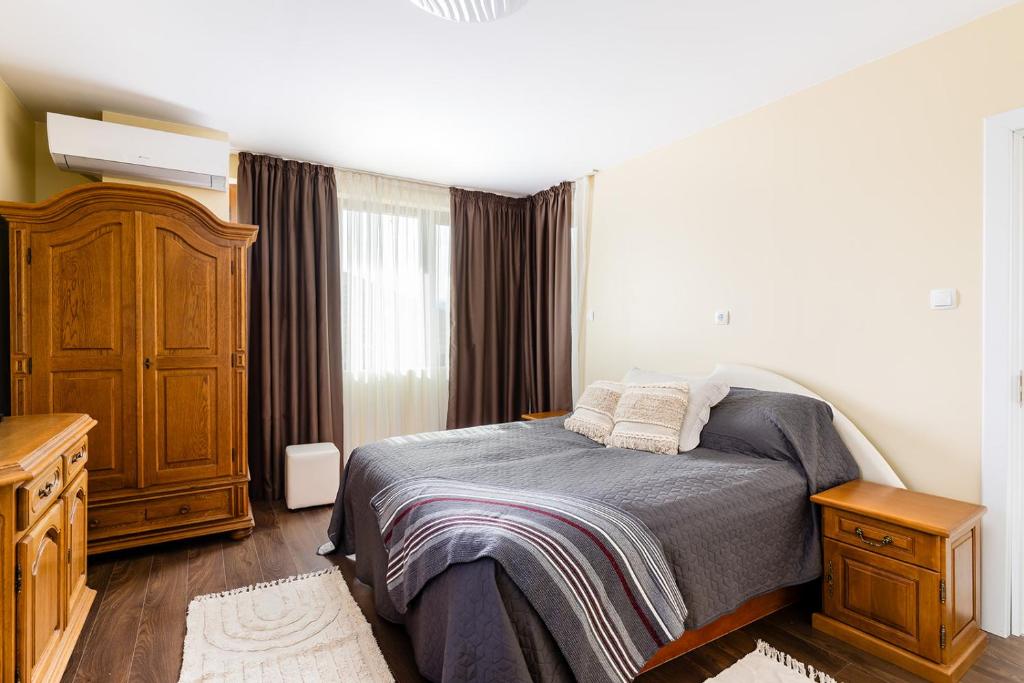 Un dormitorio con una cama y una cómoda de madera. en Vila Roza, 