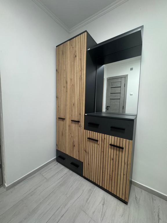 a bathroom with a mirror and a wooden cabinet at YarNika in Berehove