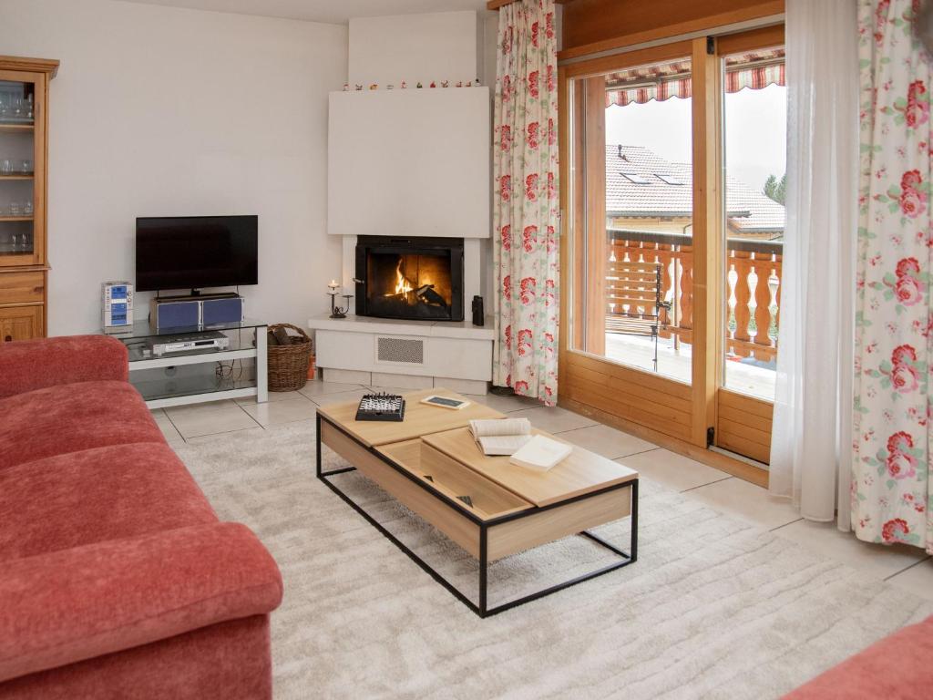 a living room with a couch and a coffee table at Apartment Réze 5 by Interhome in Ovronnaz