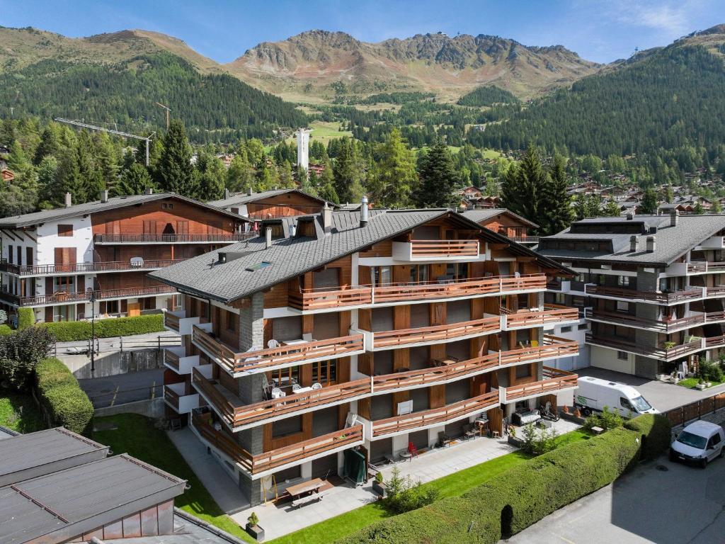 an aerial view of a building with mountains in the background at Apartment Val Neige 11 by Interhome in Verbier