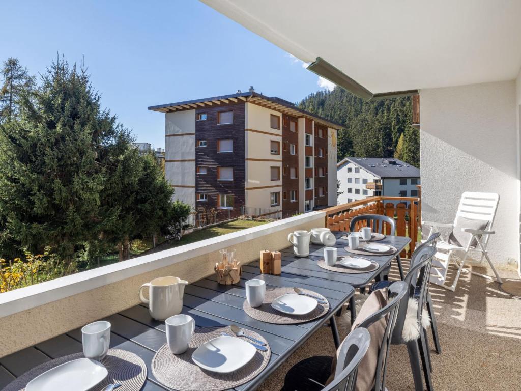 a table and chairs on a balcony with a view at Apartment Vermala Soleil B1 by Interhome in Vermala