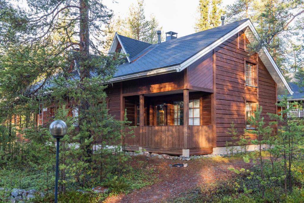 a log home with a gambrel roof at Koda Halo Lodge - Sauna, Parking & Playstation in Rovaniemi