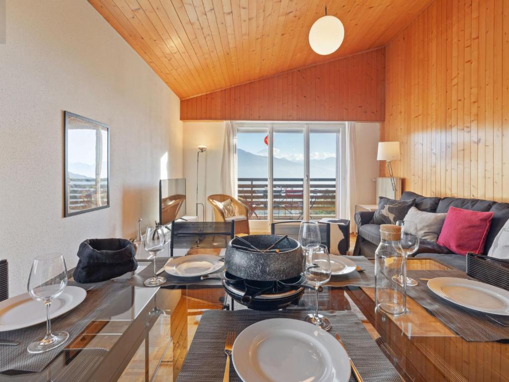 a dining room with a table with wine glasses at Apartment Belmont Est 80 by Interhome in Vermala