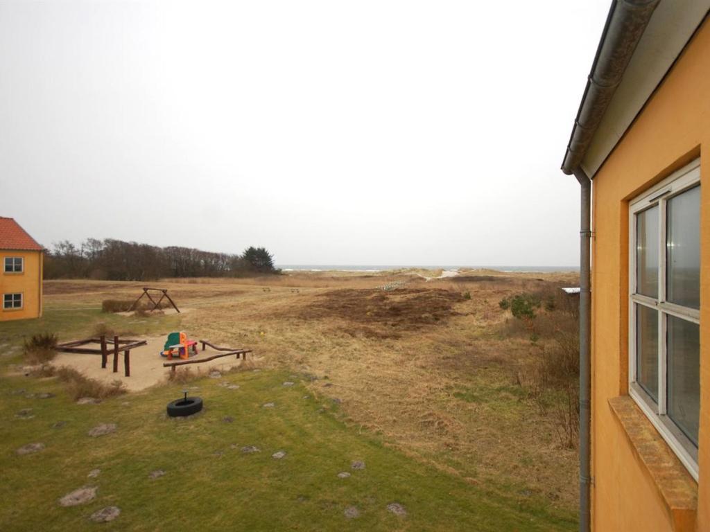 a view of a field from a window of a house at Apartment Runhild - 100m from the sea by Interhome in Hals