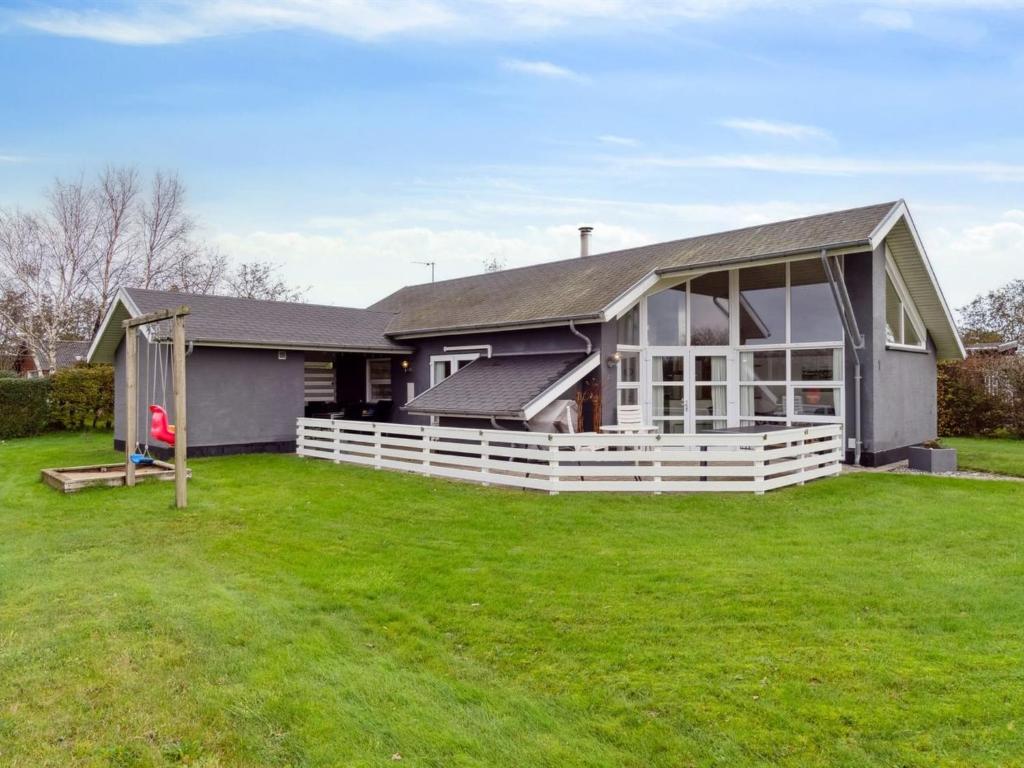 a house with a large lawn in front of it at Holiday Home Thrugels - 600m from the sea by Interhome in Hadsund