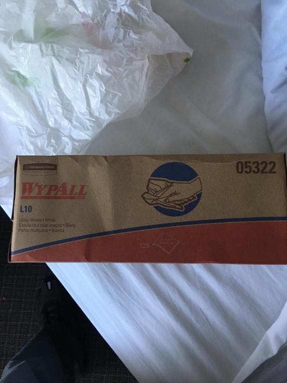 a pizza box sitting on top of a bed at Budget Inn near WestRock in Covington