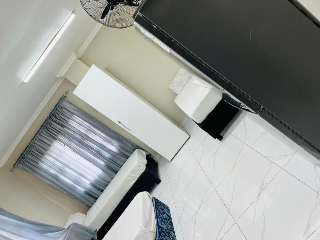 a small bathroom with a toilet and a window at Sunset in Durban