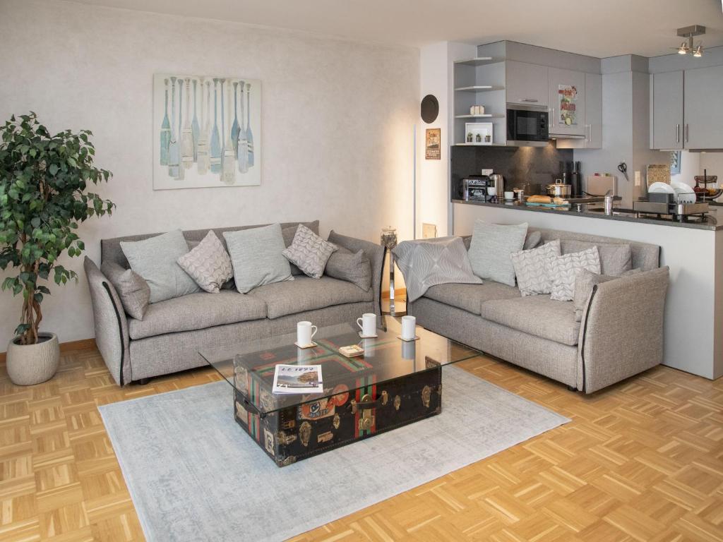 a living room with two couches and a coffee table at Apartment Residenz Marina-63 by Interhome in Bouveret