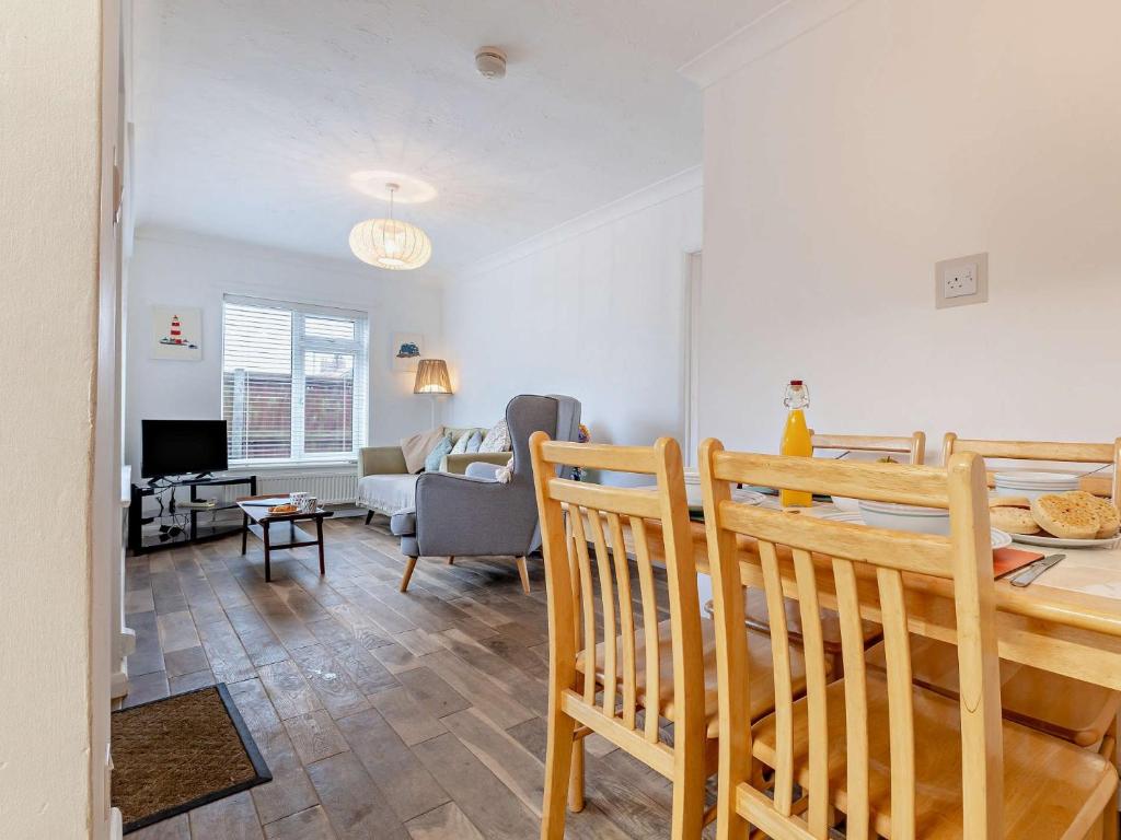 a living room with a table and a dining room at 2 Bed in Bacton 75392 in Bacton