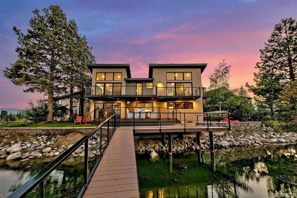 a large house with a dock in the water at 2030 Marconi Way home in South Lake Tahoe
