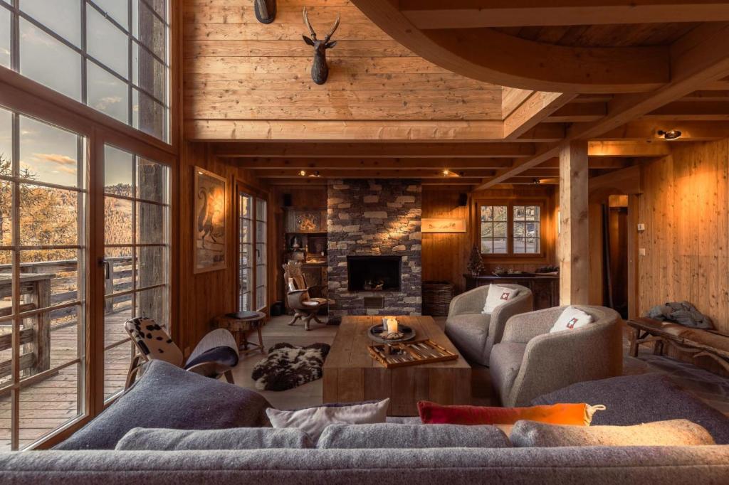 a living room with a couch and a fireplace at Chalet La Tsoum in Riddes
