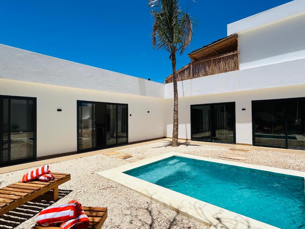 a swimming pool in the backyard of a house at U Paradisu Villas- 2 private pool villas in Kibigija