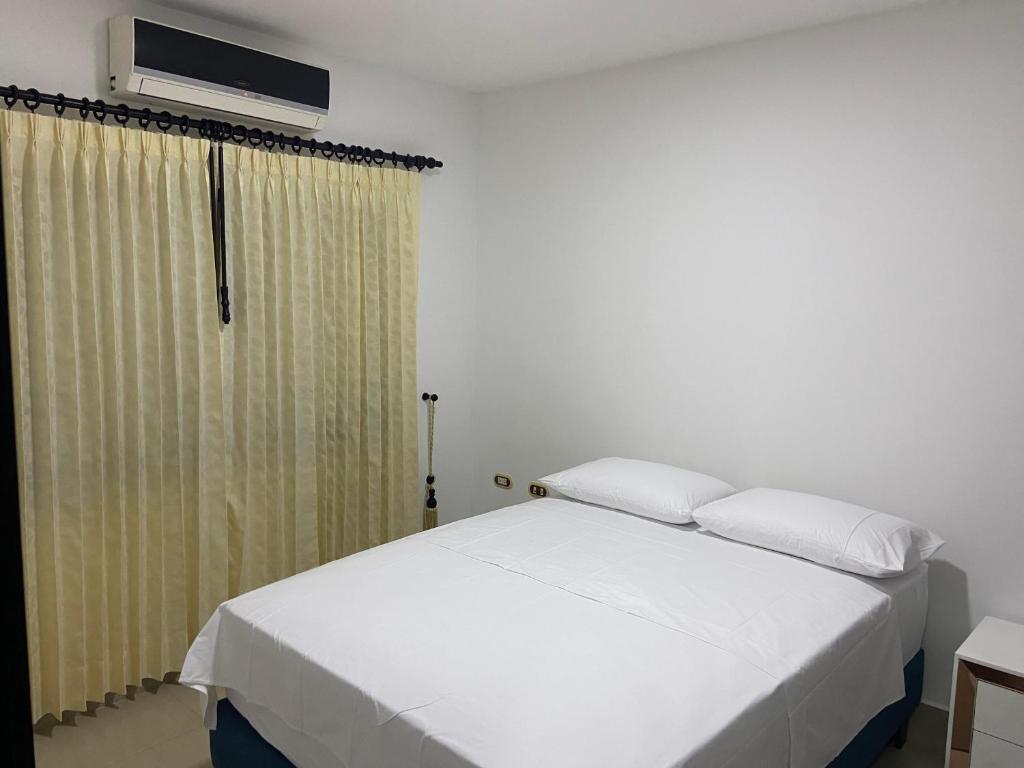 Ένα ή περισσότερα κρεβάτια σε δωμάτιο στο Apartahotel la Villa R&C