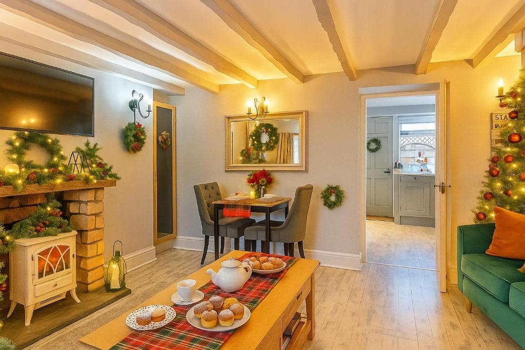 a living room with a christmas tree and a table at Charming Shepherd's Cottage, Pets Welcome,parking in Bridgend