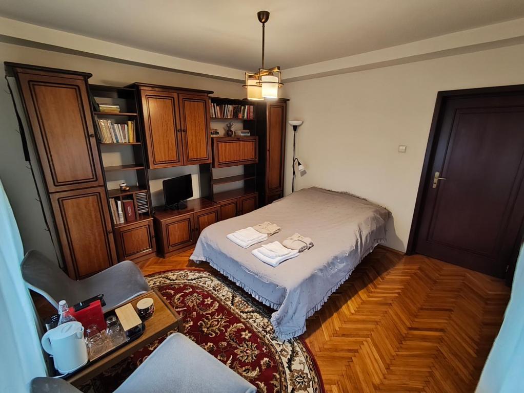 a bedroom with a bed and a chair and a table at Casa Paul in Craiova