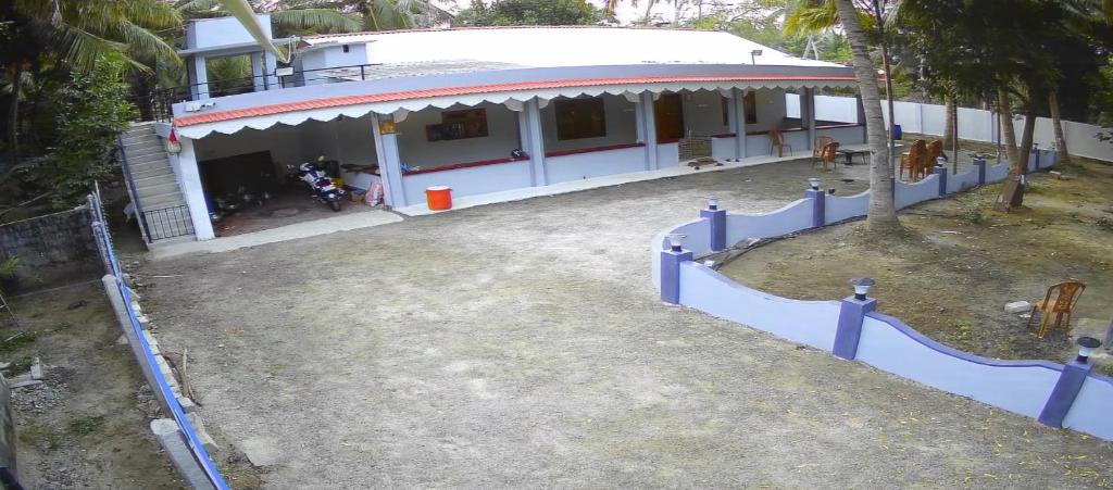 a white house with a fence in front of it at DNN Brothers Villa in Jaffna