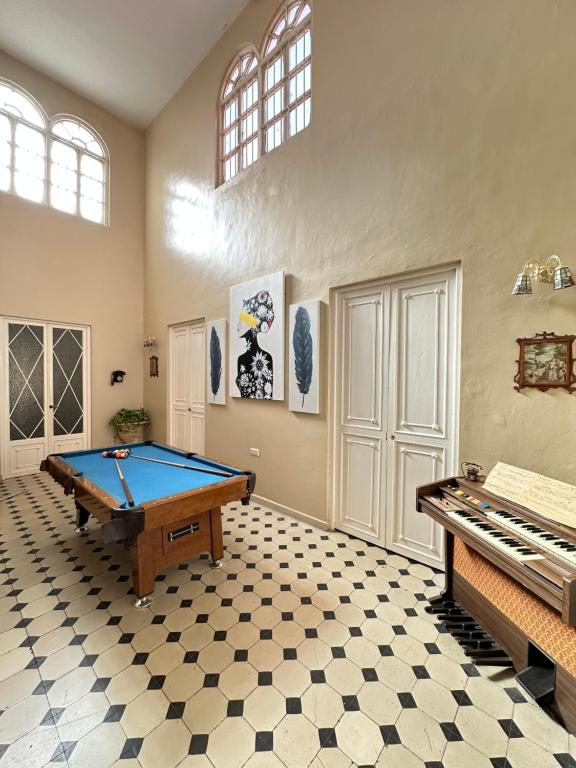 a room with a pool table and a piano at Great House Almería in Almería