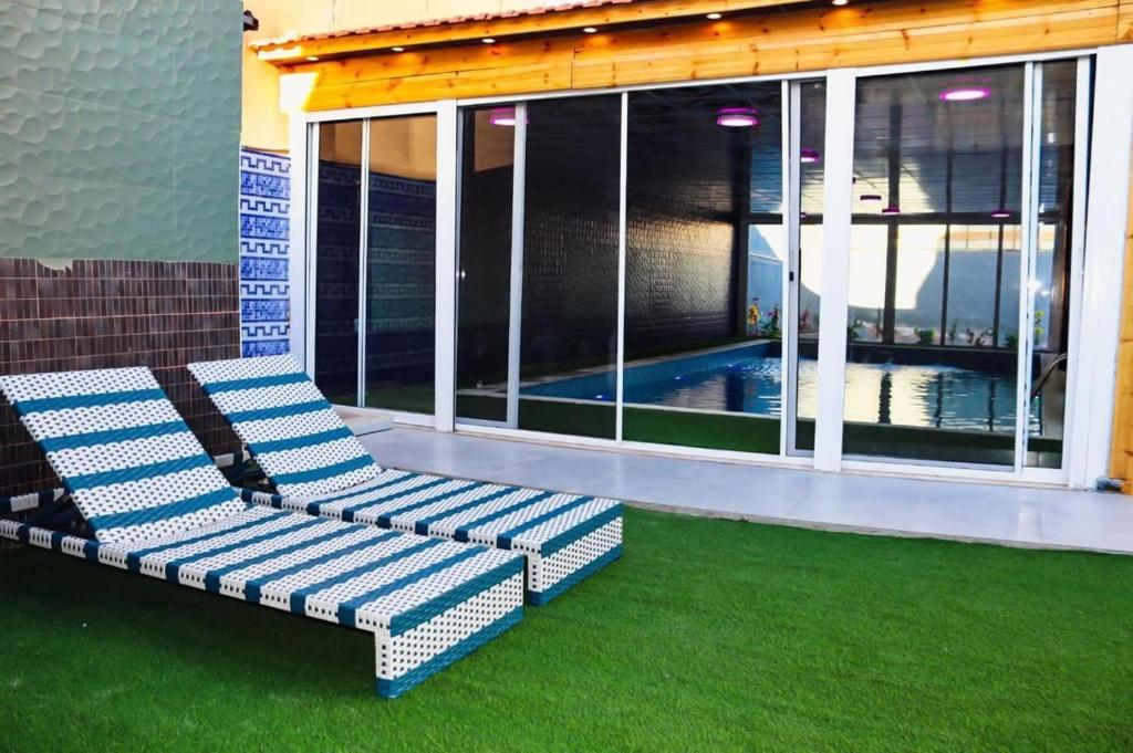 a blue and white couch sitting on a patio at Marina Privet chalet for rent in Al Jafr