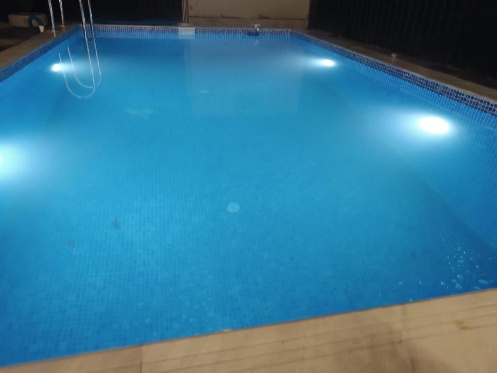 a large swimming pool with blue water at The Mountain A-Frame Qusar in Yuxarı Lǝgǝr