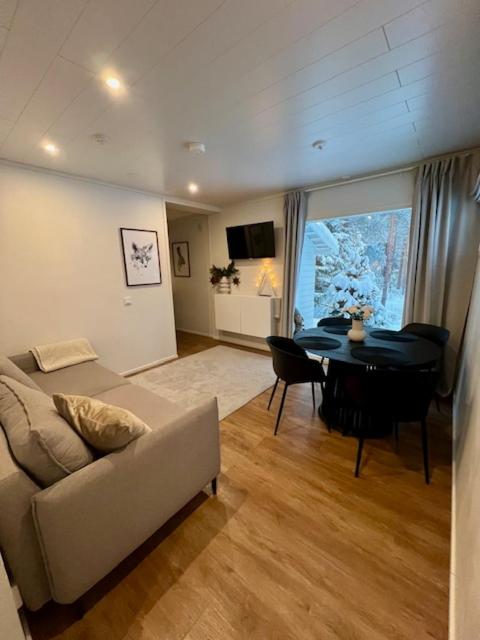 a living room with a couch and a table at Arctic Circle Guesthouse in Rovaniemi