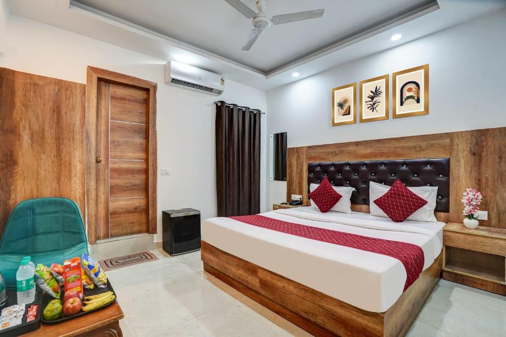 a hotel room with a bed and a chair at Hotel City Lite Near Delhi Airport in New Delhi