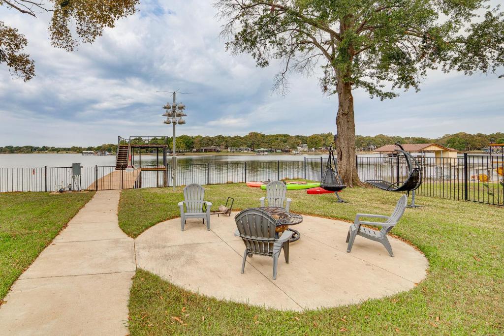 a patio with chairs and a table and a playground at Private Dock and Yard! Modern Getaway in Mabank in Enchanted Oaks
