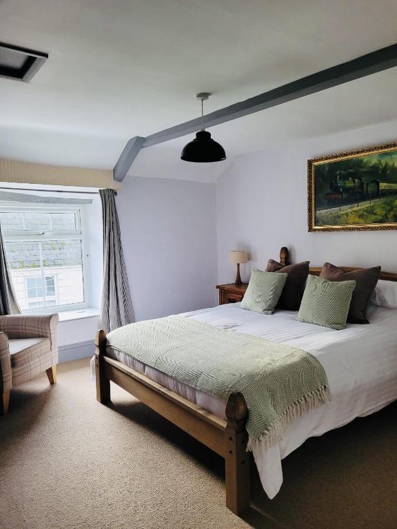 a bedroom with a large bed and a window at Above the Bear in Taunton