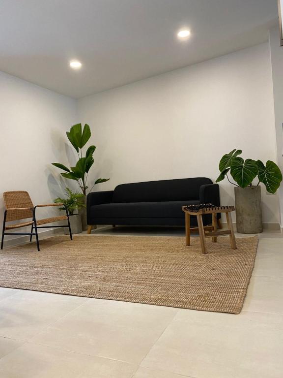 a living room with a black couch and a table at Candilejas in Fredonia