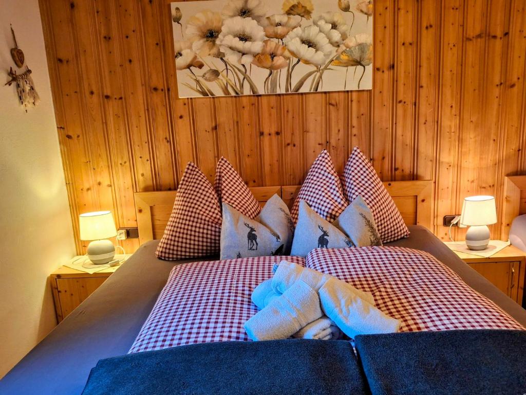 a bedroom with a bed with pillows on it at Lampererhof in Sankt Johann in Tirol