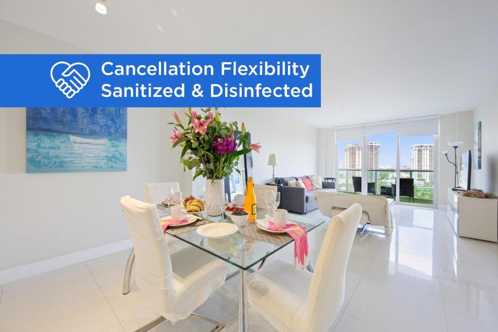 a dining room with a glass table and white chairs at Ocean Reserve 1524 in Miami Beach