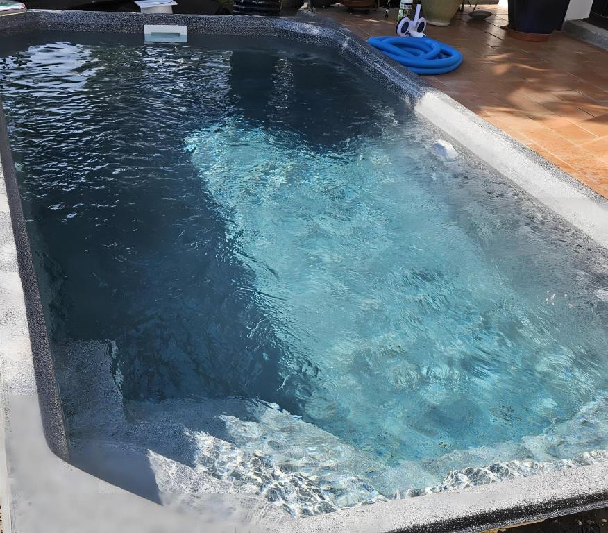 een zwembad met water erin bij Villa Zaphira in La Hume