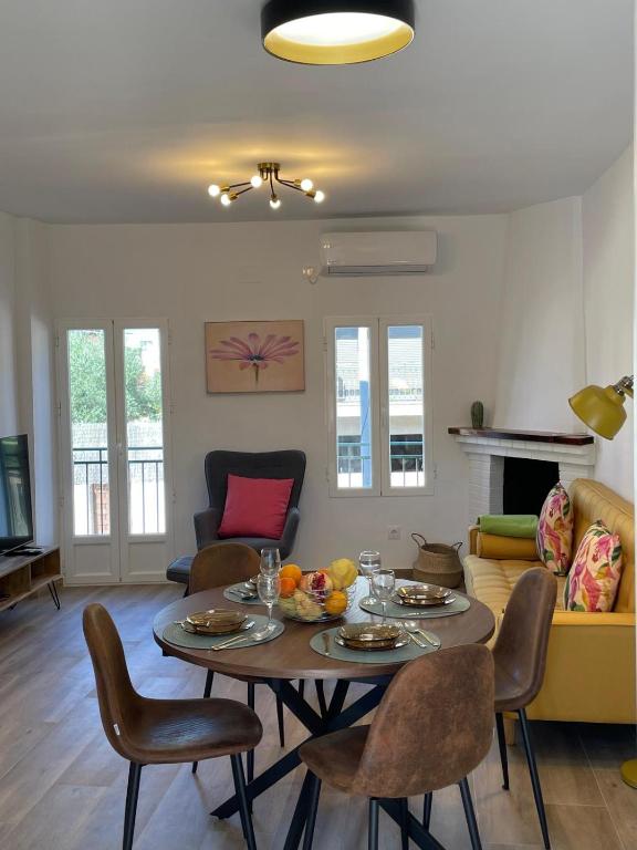 a living room with a table and chairs at Las Calas departamento ideal! in Sotillo de la Adrada