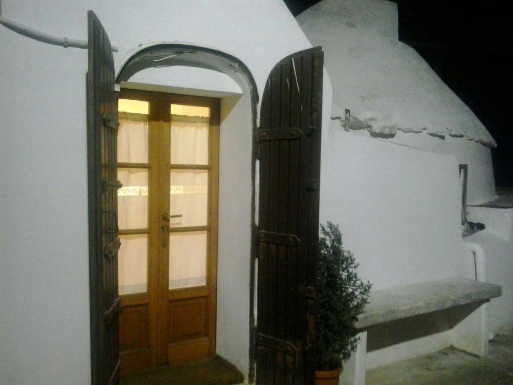 an entrance to a room with a door and a window at Trullo Mauro MGG - Trullo Fragale in Martina Franca