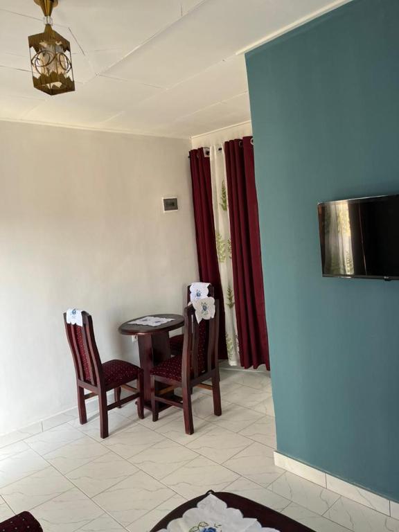 a dining room with a table and two chairs at Chance junior 