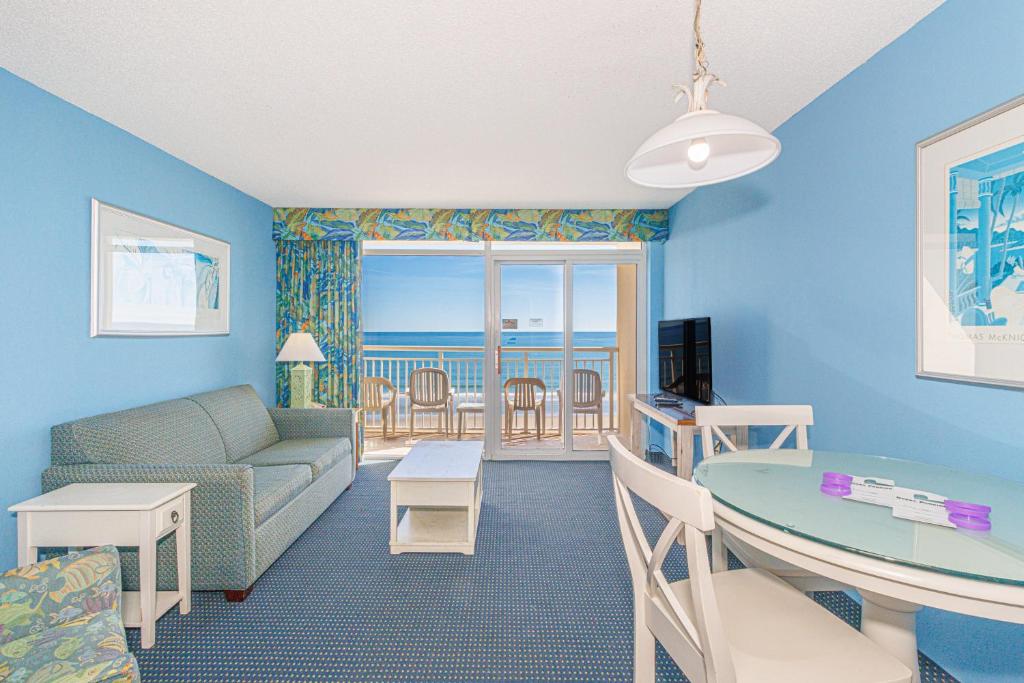 a living room with a couch and a table at Spacious 1 BR Condo-Breathtaking Oceanfront Views! Bay Watch 706 in Myrtle Beach