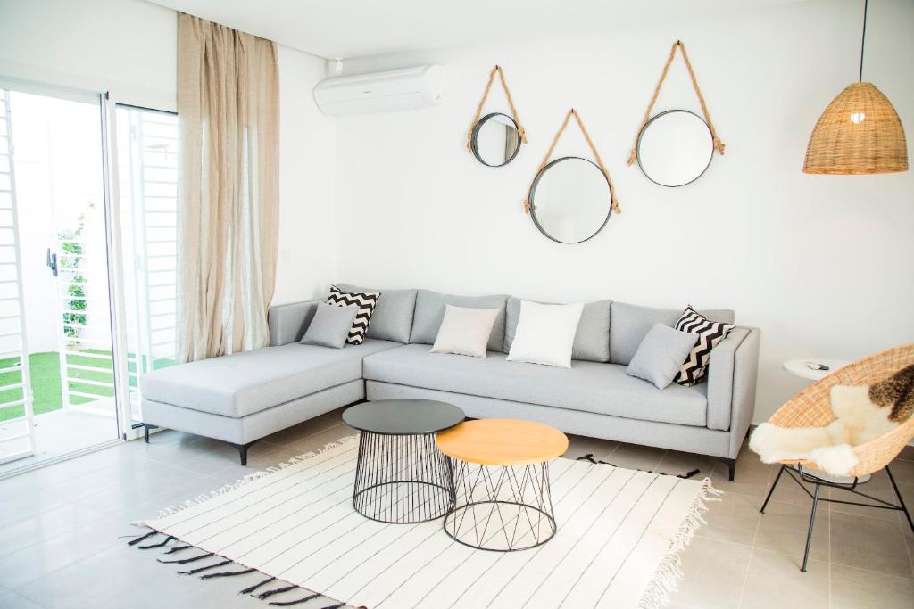 a living room with a couch and a table at Modern with garden 5mn from Carthage and Lac in Sidi Daoud