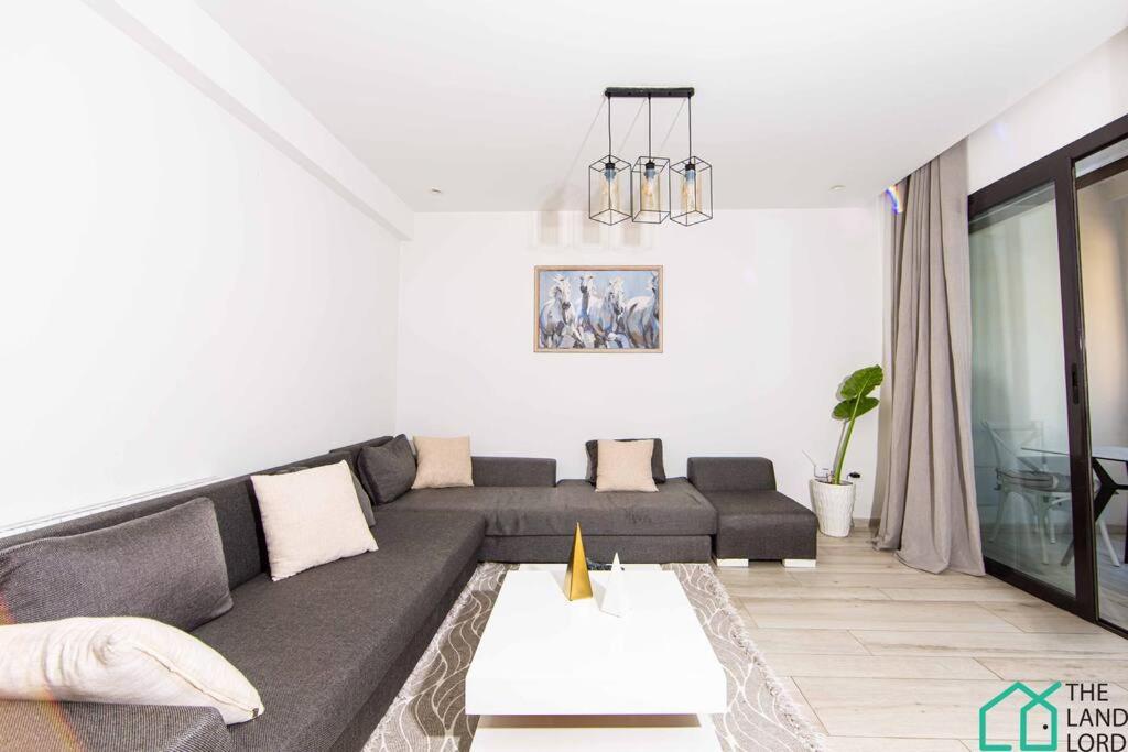 a living room with a couch and a table at B13 New cosy 1 bedroom in La Marsa in Sidi Daoud