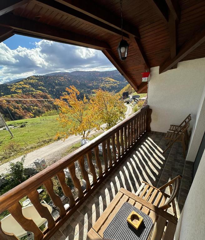 a balcony with a table and a view of a valley at Apartmani Dunja Zlatar in Nova Varoš