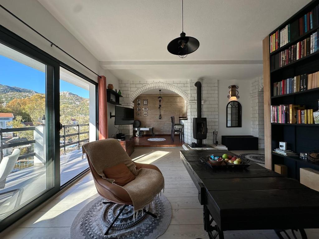 a living room with a chair and a table at Lux Apartment Sunset in Virpazar