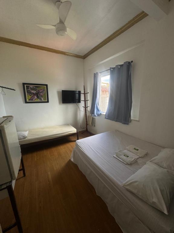 En eller flere senge i et værelse på Bendita Pousada