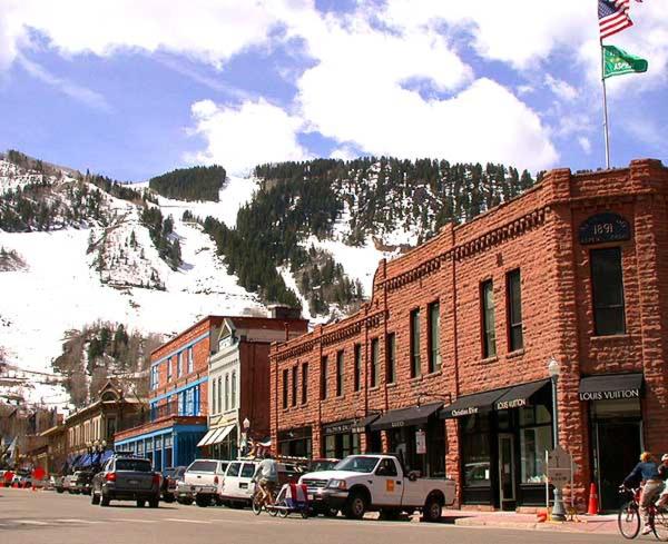 a street in a town with a mountain in the background at Mountain Sky Stay in Aspen