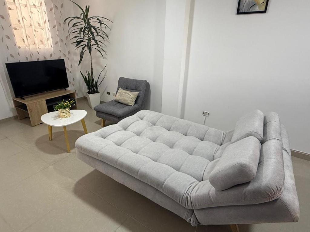 a living room with a couch and a tv at Apartamento Limón Azul in Sogamoso