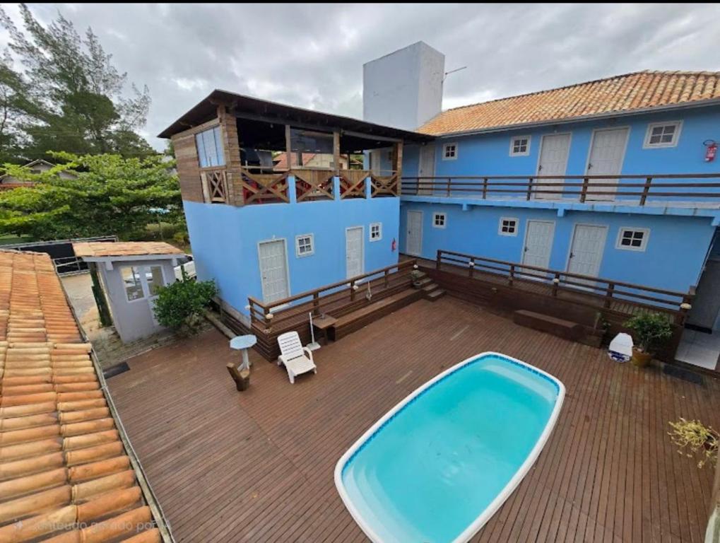 an aerial view of a house with a swimming pool on a deck at Porto Pousada in Imbituba