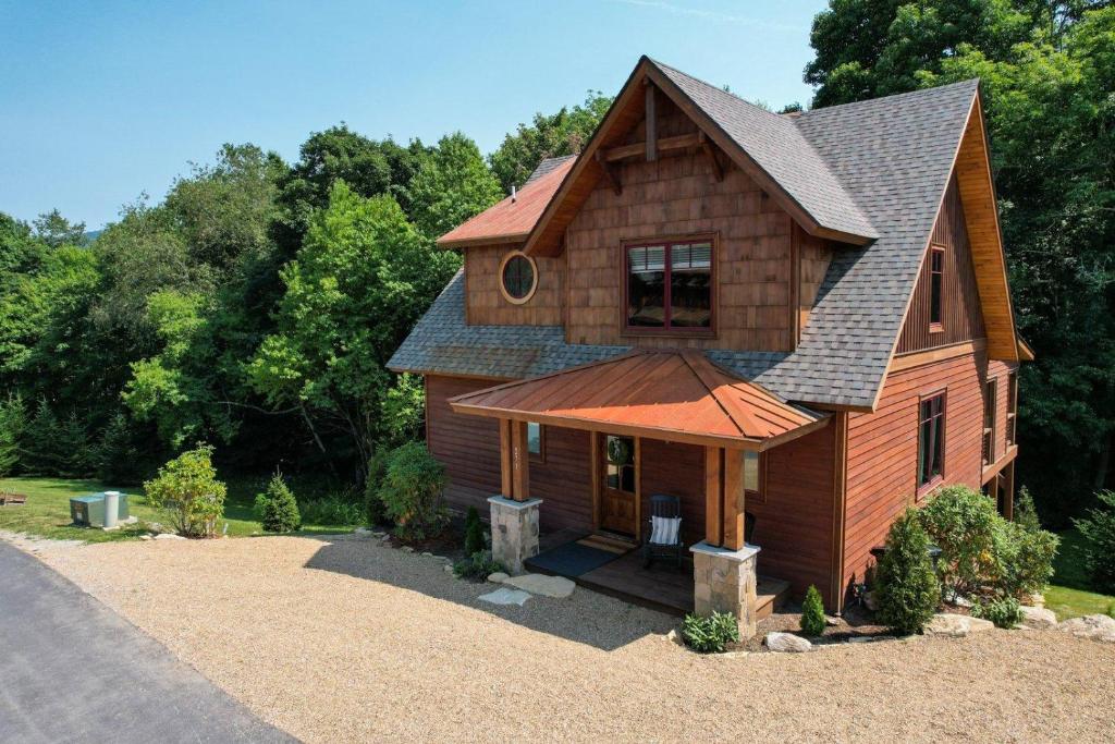 a wooden house with a gambrel roof at Overlook Nook at Eagles Nest in Elk Park