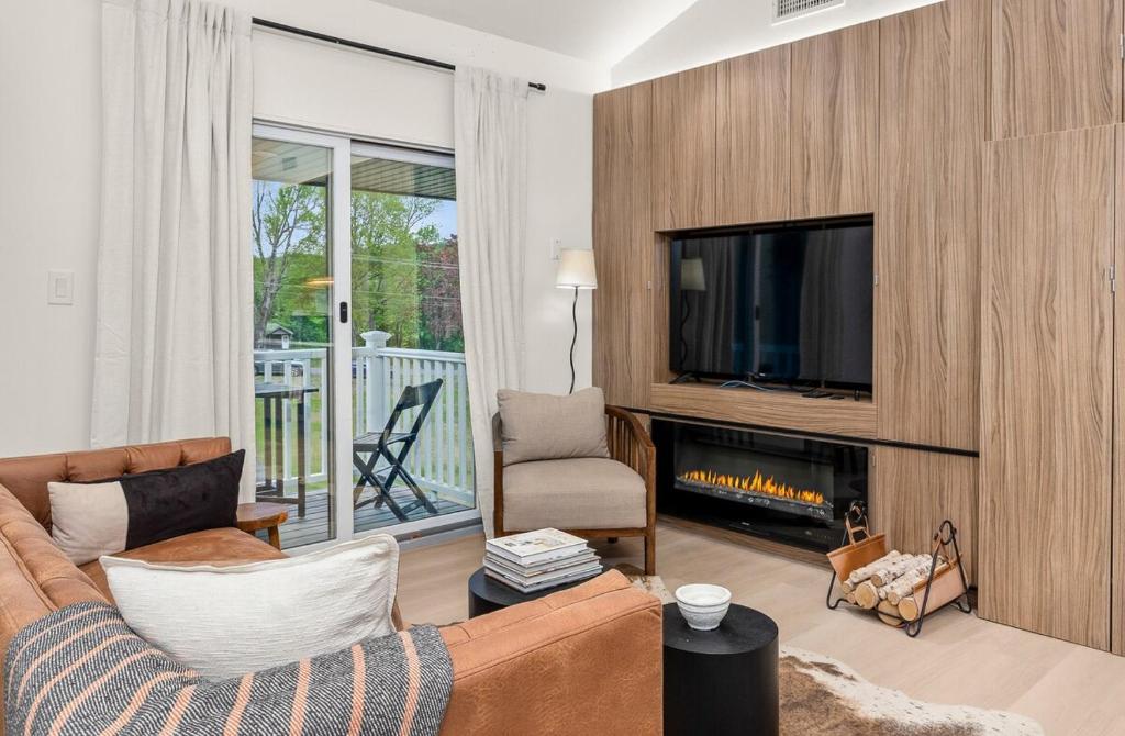 a living room with a couch and a fireplace at Pond House at Carter Bridge Estate in Freehold