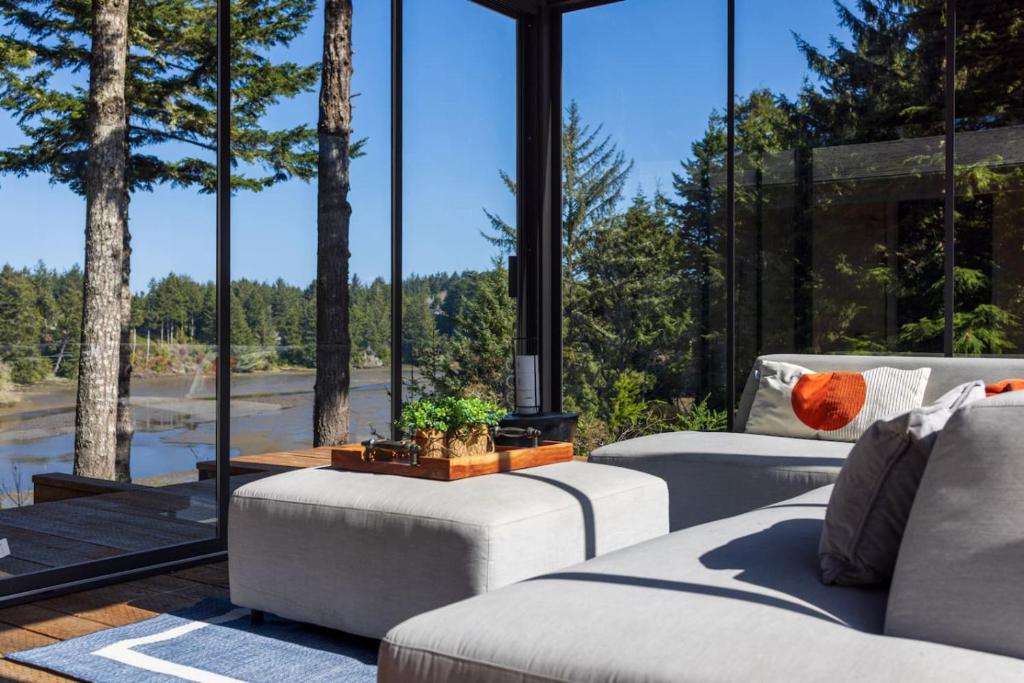 a living room with two couches and a large window at Crown Point Hideaway in Crown Point