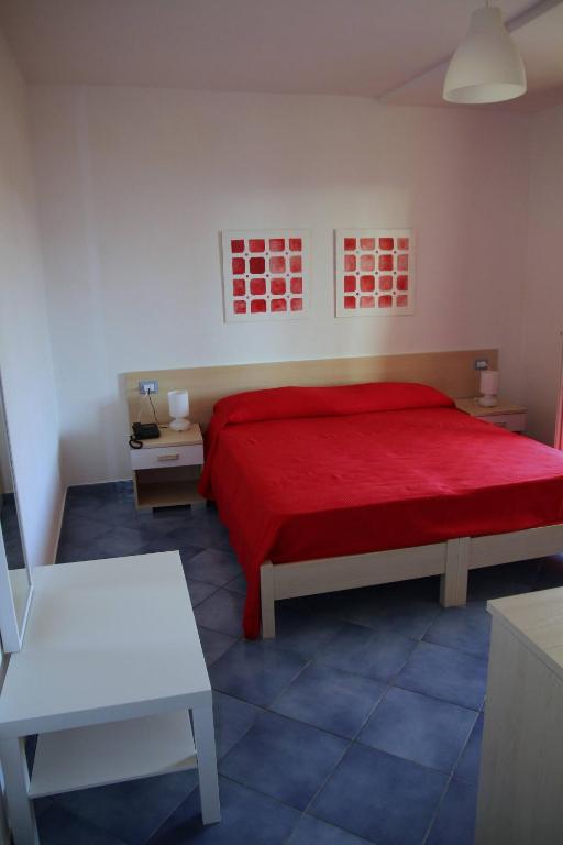 a bedroom with a bed with a red bedspread at Belvedere in Procida