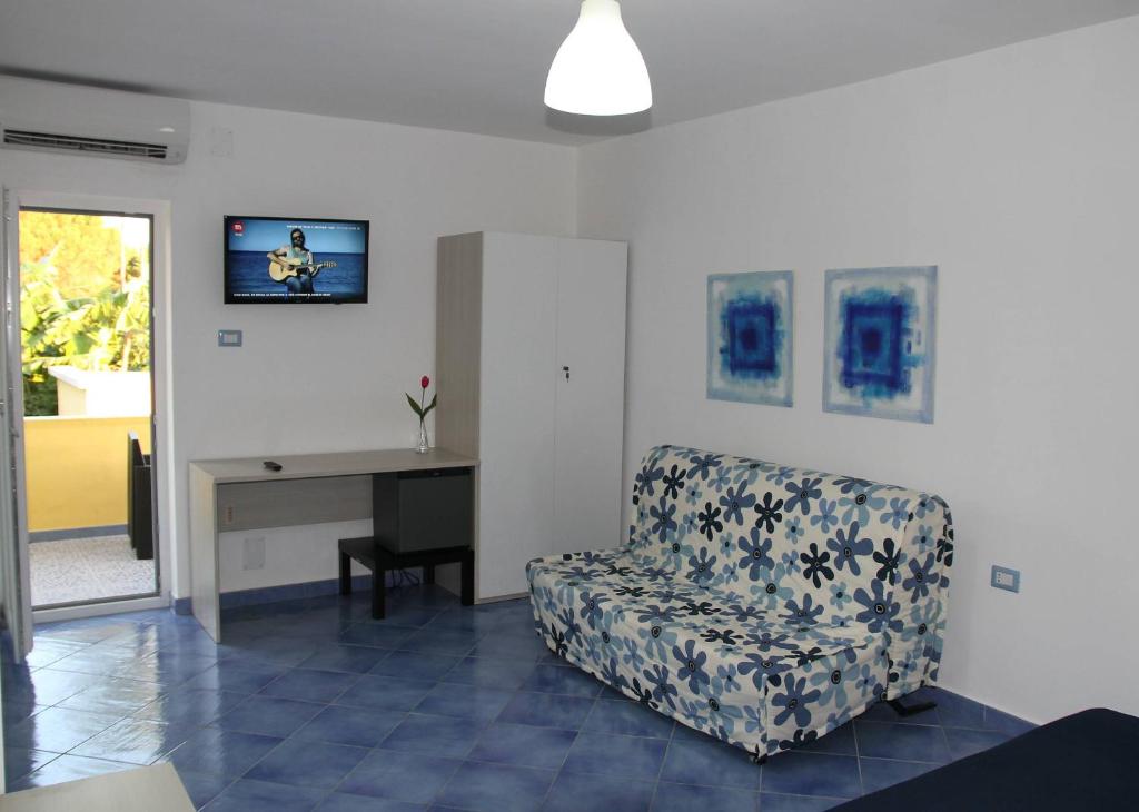 a living room with a chair and a desk at Belvedere in Procida