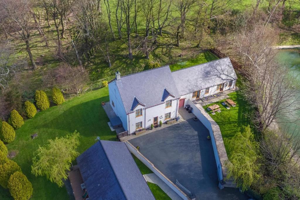 an aerial view of a house with a blue roof at Ty-Ffynnon in Penmaen-mawr