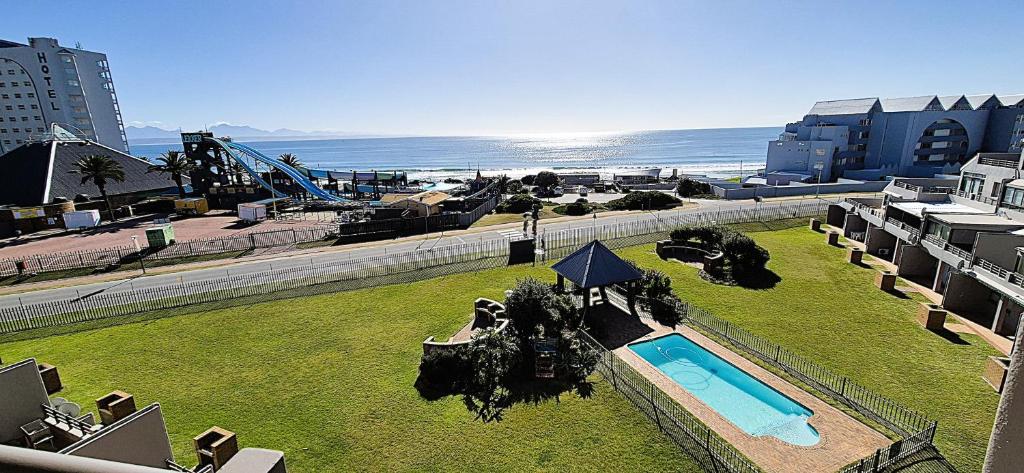 an aerial view of a resort with a pool and the ocean at 59 De Valle, Diaz Beach in Mossel Bay